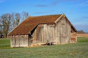 old wooden barn in a field in upper bavaria
