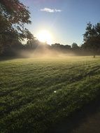 Foggy Sunrise above meadow at autumn