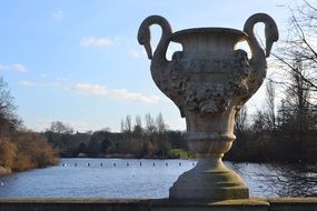 large stone vase near the lake in the park