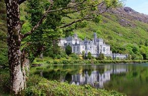 Landscape of big white castle on a river bank