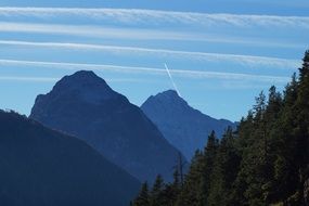mountains on the background of coniferous forest at dusk