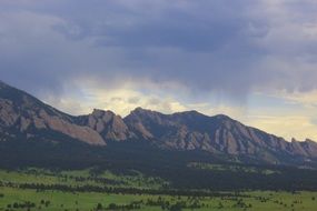 mountains during a storm with cloudy sky