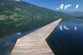 wooden pier on a lake in the mountains