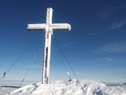 Cross on the summit of the mountain in the winter