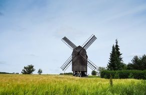 wooden Windmill in field on a sunny day