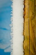 Snow on Wooden pole in Winter Sunny day