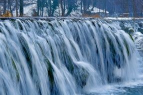 landscape of cascade waterfall in a cold winter