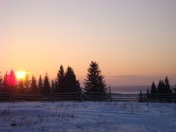 distant view of a sunset over a snowy landscape in the Urals