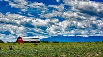 white clouds over a farm in colorado