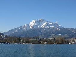 distant view of the city of Lucerne near the lake and snowy mountains