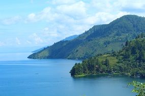 green seafront mountains