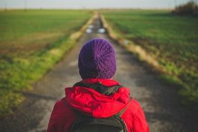 man in a red jacket on the road