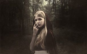 girl in the forest like a red riding hood
