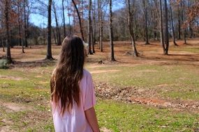 girl with beautiful long hair in the autumn park