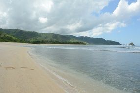 paradise sandy beach under a cloudy sky