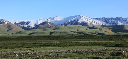 green and snow-capped Mountains in beautiful landscape, Kyrgyzstan