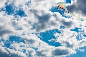 kite flying under the clouds