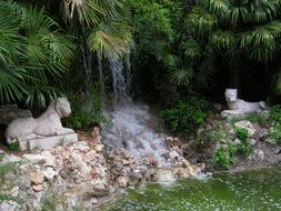 sculptures of lions near the waterfall