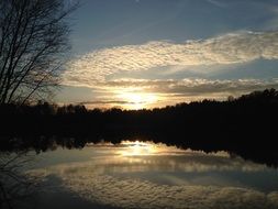 mysterious sunset over a forest lake