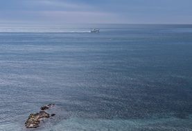 distant view of a boat at sea off the coast , spain, malaga