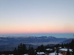 moon over the alps in pink twilight, france