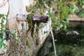 water flows from metal pipe