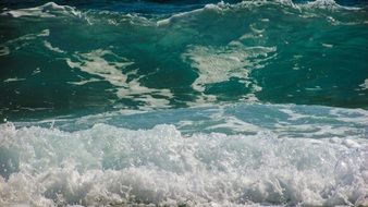 azure ocean waves with white foaming close-up