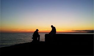 silhouettes fishermen at sunset