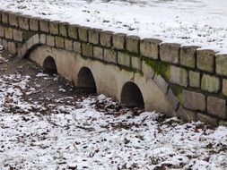 stone bridge in the snow in winter