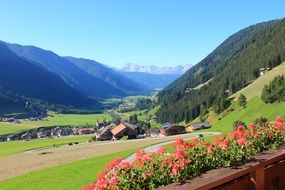 buildings in a green valley in the mountains