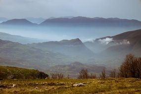 Landscape with the mountains in the haze on the horizon