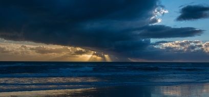 dark clouds over the sea during sunset