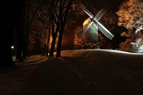 landscape of winter mill in the snowy evening