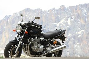 black motorcycle on a background of mountains