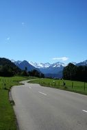 asphalt road in the mountains of bavaria on a sunny day