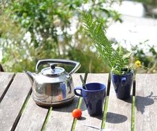 steel kettle and two mugs outdoor