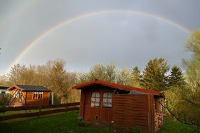 rainbow over old wooden buildings
