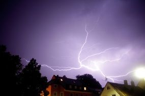 thunderstorm in the night sky over the village