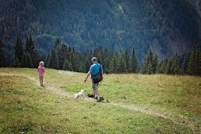 man and child Hiking on mountain trail