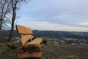 wooden bench on a hill above the village