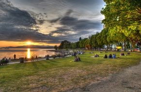 Landscape of the people on a beach at the sunset