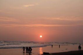 people in Sea, silhouettes at Sunset