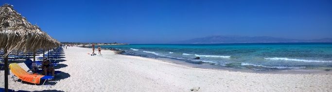 blue loungers on the beach of Crete