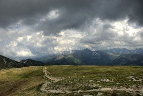 mountains green hills dark sky view