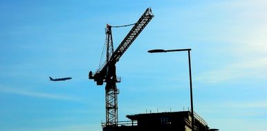 high construction crane in blue sky