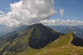 top of the mountain and the curly clouds