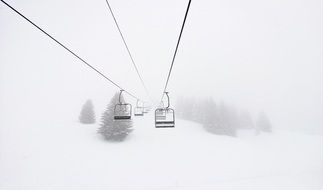 Cable Cars above Snowy Mountain in fog