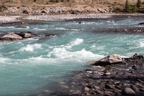 Athabasca River, Rapid foaming water flow among rocks, canada