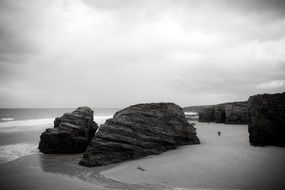 large stones on a white sand beach