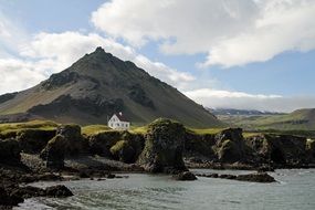 distant view of the house among the picturesque landscape of Iceland